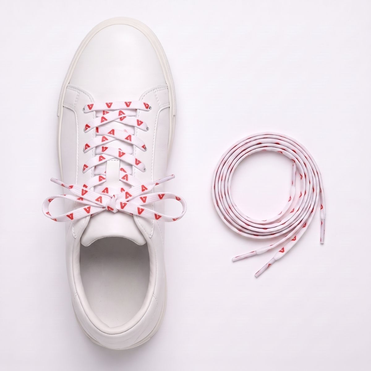 Custom printed logo shoelaces displayed with a white sneaker, highlighting premium branded shoelaces for promotional and corporate use.
