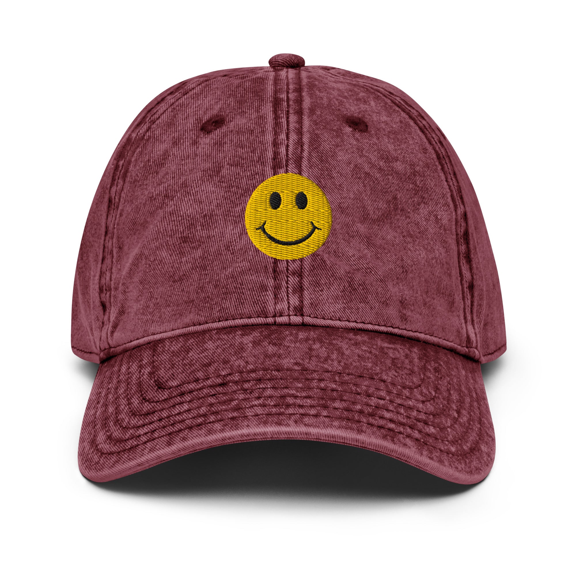 Maroon smiley face embroidered baseball cap with adjustable fit, washed-out design for everyday wear and street style.