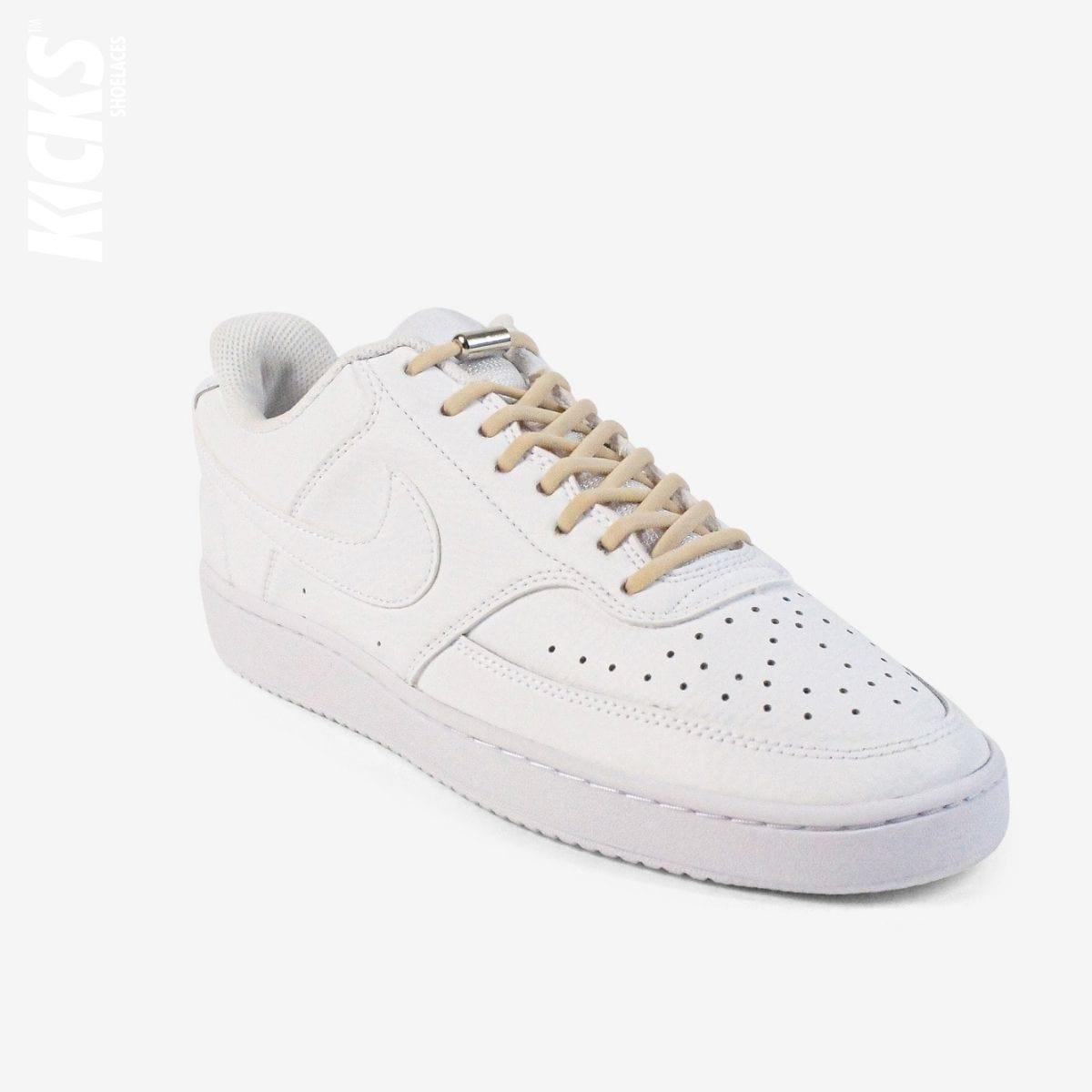 Beige oval no-tie elastic shoelaces installed on white sneakers by Kicks Shoelaces