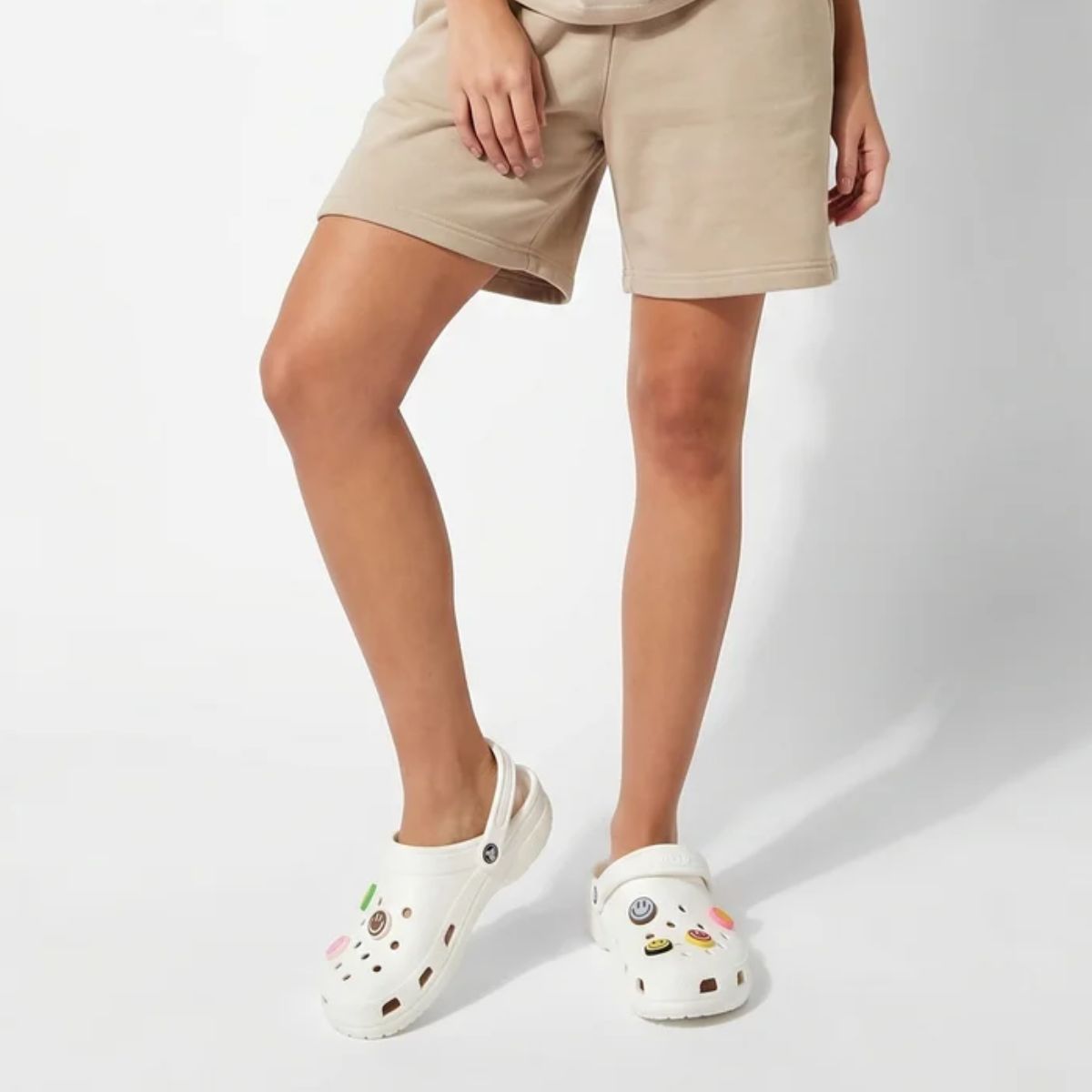 Young female model wearing casual streetwear styling with Crocs and colorful charms by Kicks Shoelaces