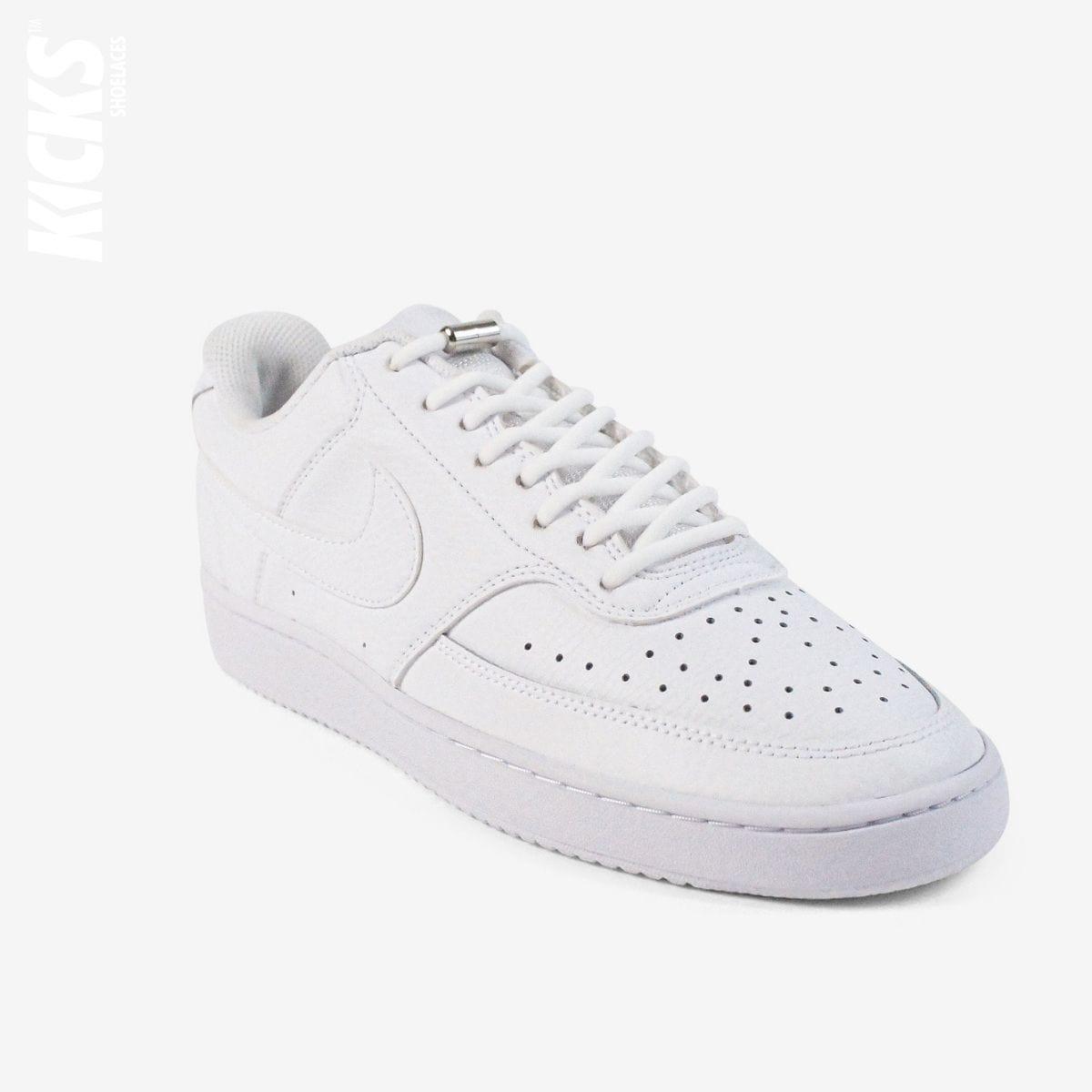 White oval no-tie elastic shoelaces installed on white sneakers by Kicks Shoelaces